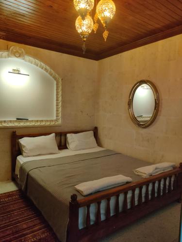 a bedroom with a large bed with a mirror at Ktisis Butik Otel in Urfa