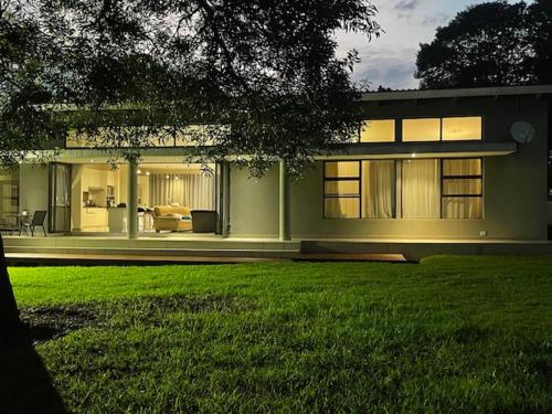 a large house with a lawn in front of it at StoneWall Villa in Mbabane