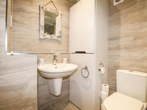 a bathroom with a sink and a toilet at Sunrise Apartment in Weymouth