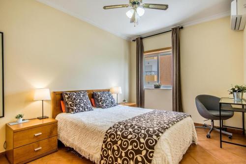 アルマカオ・デ・ペラにあるApartamento Mar Salgadoのベッドルーム1室(ベッド1台、デスク、椅子付)