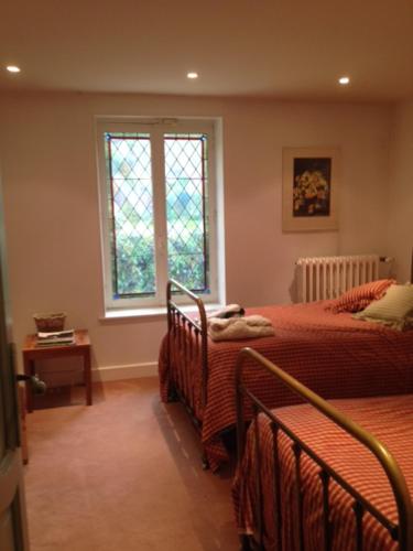 a bedroom with two beds and a window at cottage à bethemont la foret in Béthemont-la-Forêt