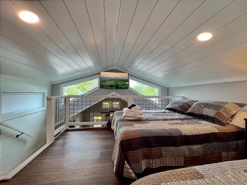 a bedroom with two beds and a flat screen tv at Retreat on the Lake in Hiawassee