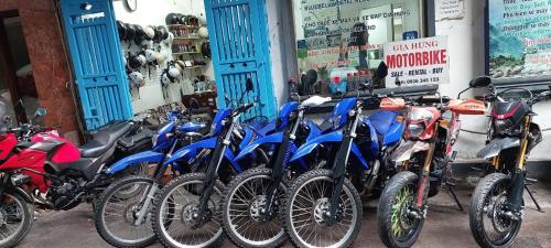 a row of motorcycles parked in front of a store at Gia Hung Motorbike & Home Stay in Hanoi