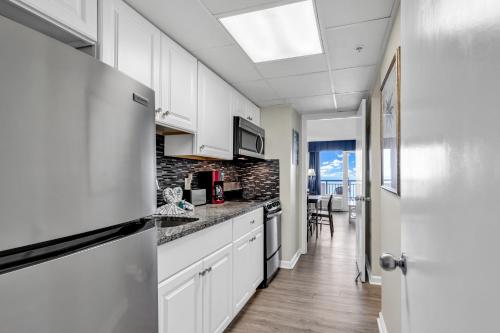 a kitchen with white cabinets and a skylight at Boardwalk Resort 537 in Myrtle Beach