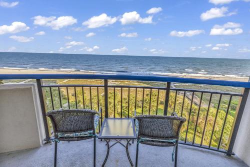 two chairs and a table on a balcony with the ocean at Boardwalk Resort 537 in Myrtle Beach