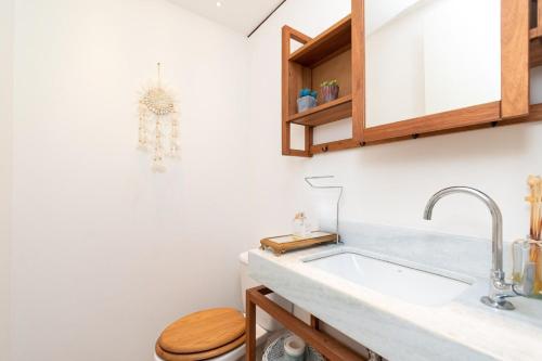 a bathroom with a sink and a toilet at Santa Serra Itaipava in Itaipava