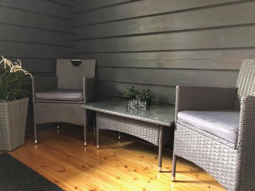 a table with two chairs and a table with glasses on it at Stuga Pörsvik in Nauvo