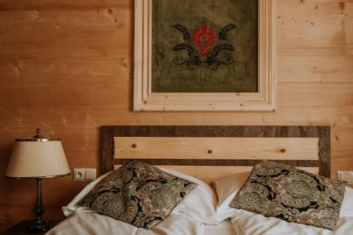 a bed with two pillows on it in a room at Gordonówka Grand- blisko basenów termalnych Rezerwuj już dziś- nie przegap okazji! in Szaflary
