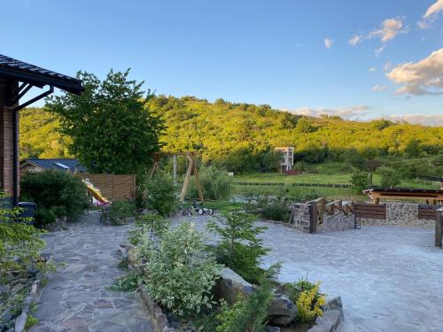 a backyard with a garden with trees and a mountain at BrickWood in Verkhniy Koropets
