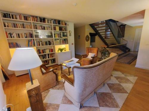 a living room with a staircase with bookshelves at Hotel Boutique Villa de Palacios - Palacio de Aras in San Miguel de Aras