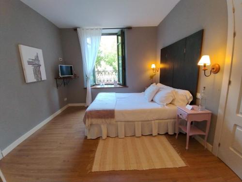 a bedroom with a large bed and a window at Hotel Boutique Villa de Palacios - Palacio de Aras in San Miguel de Aras