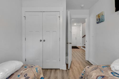 a bedroom with white walls and a white closet at Seabreeze Cottages- 2405 Seabreeze Place in Myrtle Beach