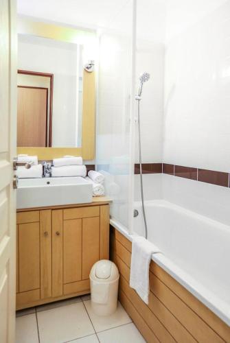 une salle de bain avec une baignoire, un lavabo et des toilettes dans l'établissement Résidence Le Beach - maeva Home - 2 Pièces 5 Personnes Confort MAE-2167, à Trouville-sur-Mer
