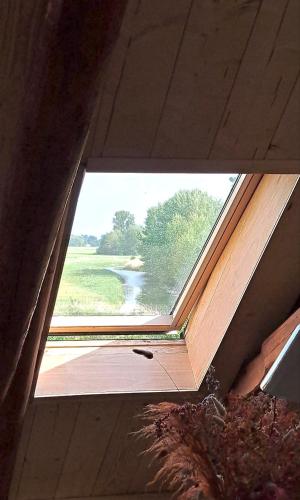 a window in a room with a view of a river at Ark van Thesinge in Thesinge