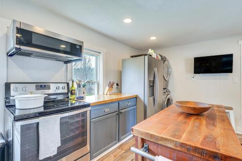 a kitchen with a wooden table and a refrigerator at Lovely Ludlow Farmhouse about 1 Mi to Town and Slopes! in Ludlow