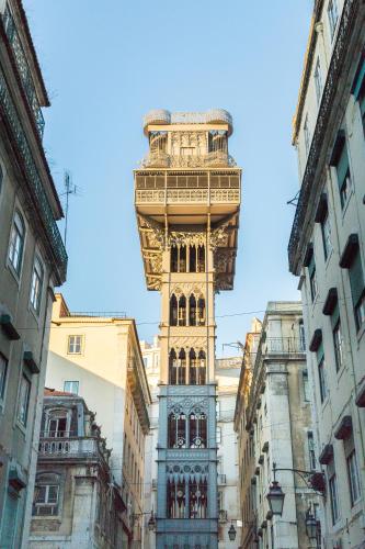 a tall building with a tower on top of it at Lisboa Central Park Hotel Suites & Studios in Lisbon