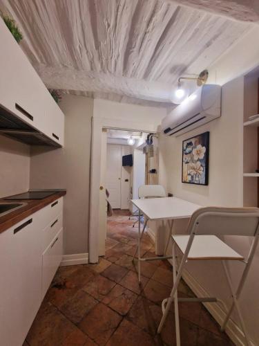a kitchen with a table and chairs in a room at LEONARDO Loft NAPLES in Naples