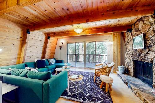 a living room with a couch and a fireplace at Hidden Wonder in Crestline