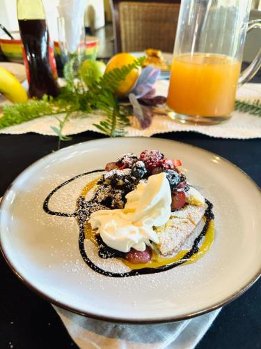 a white plate with a dessert on a table at Khandizwe Kruger Villa in Malelane