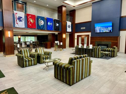 a lobby with chairs and a fireplace and a bar at La Quinta by Wyndham Bannockburn-Deerfield in Bannockburn