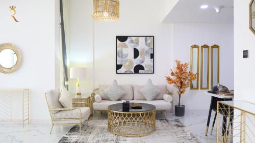a living room with a couch and a table and chairs at City Nest 2BR - Stylish Urban Oasis in Abu Dhabi