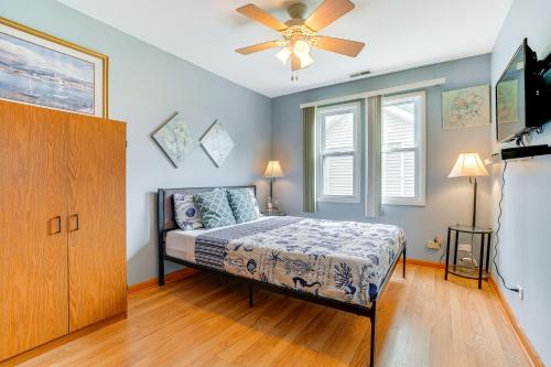 a bedroom with a bed and a ceiling fan at Kayak, Fish, Boat and Swim Home Near Lakeside Park! in Woodland Beach
