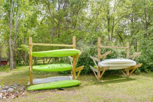 a couple of green chairs sitting in the grass at Riverfront Shenandoah Getaway with Kayaks and Tubes! in Shenandoah