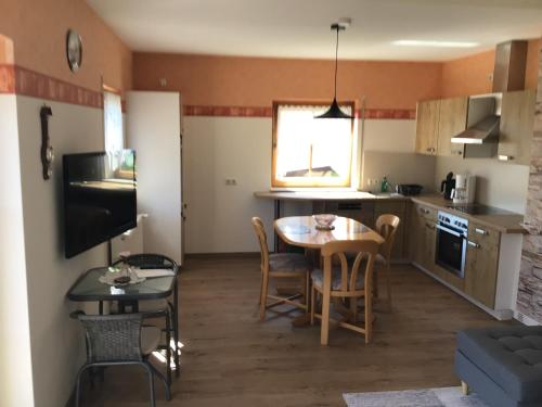 a kitchen and dining room with a table and chairs at Ruhige Ferienwohnung in Schollbrunn