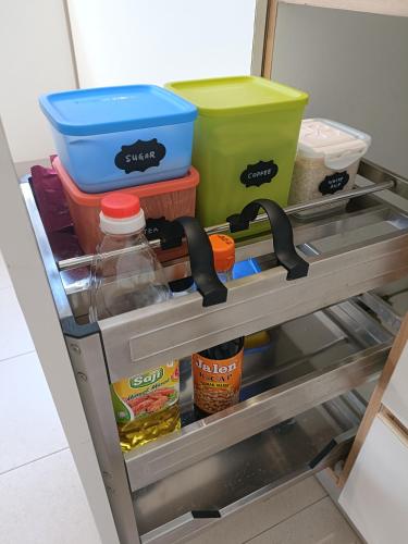 a drawer in a refrigerator filled with food at Zen Clan Homestay 15mins Sepang, KLIA, USIM, Nilai in Kampong Jijan Hilir