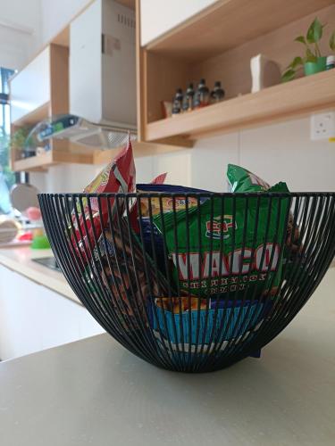 a black basket on a counter in a kitchen at Zen Clan Homestay 15mins Sepang, KLIA, USIM, Nilai in Kampong Jijan Hilir