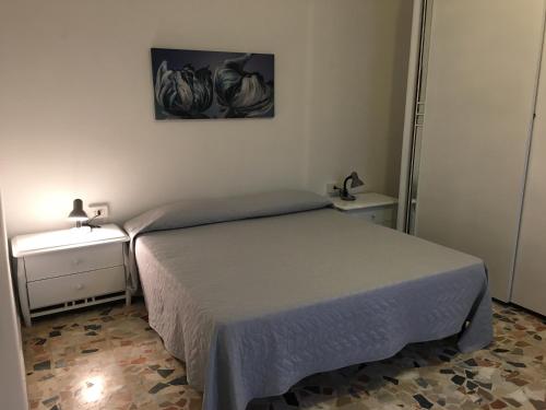 a small bedroom with a bed and two night stands at La Casetta in Campagna in Enas