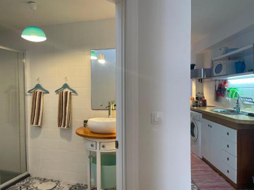 a bathroom with a sink and a sink at Casinha Azul in Horta