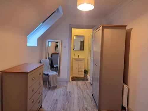 a room with a hallway with a dresser and a mirror at Connemara Ocean Escape in Galway