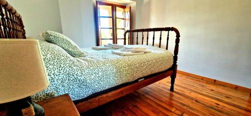 a bedroom with a bed with towels on it at Casa Ines in Ricobayo