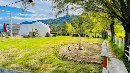 a garden with a playground and a tent at Sol y Luna Glamping in Málaga