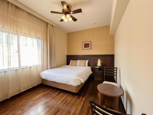 a bedroom with a bed and a ceiling fan at pension sunset beach - Vacation STAY 41239v in Imadomari