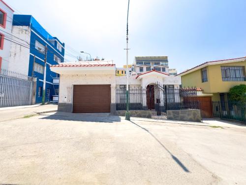 a building with a garage in the middle of a street at Casa Vallecito in Arequipa