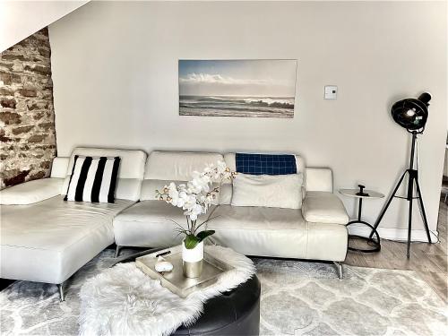 sala de estar con sofá blanco y mesa en Latakia - Heritage Tay Basin Waterfront Maisonette, en Perth