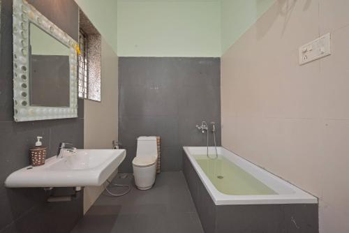 un bagno con lavandino, vasca e WC di Fortune Villa by Tropicana Stays a Lonavala