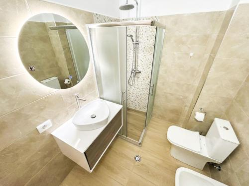 a bathroom with a toilet and a sink and a mirror at Currilave 664 in Durrës
