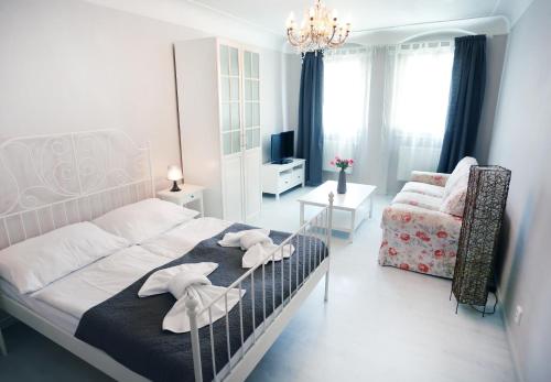 a bed room with a white bedspread and a white comforter at Apartments Pushkin in Prague