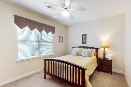 a bedroom with a bed and a ceiling fan at Friends Delight in Calabash