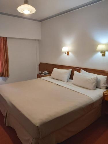 a bedroom with a large white bed with two pillows at Hotel Riogrande in Santa Fe