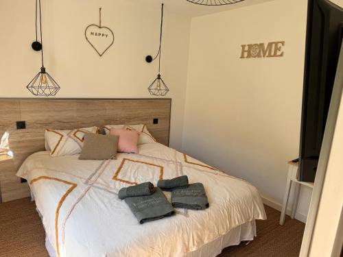 a bedroom with a bed with towels on it at La forêt in Plan-de-la-Tour