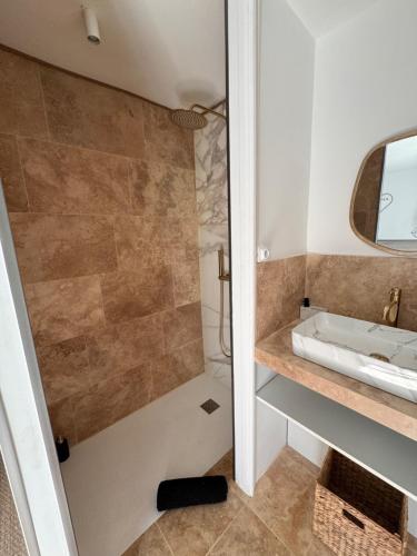 a bathroom with a shower and a sink at La forêt in Plan-de-la-Tour