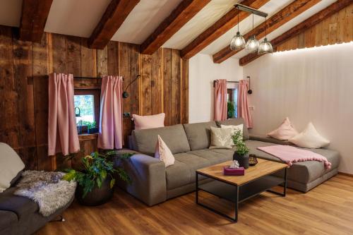 a living room with a couch and a table at Chalet Aignerhof in Flachau