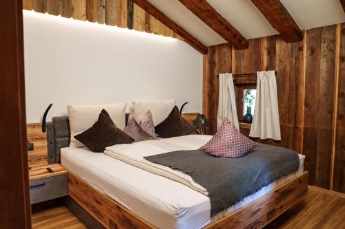 a bedroom with a bed with pillows on it at Chalet Aignerhof in Flachau