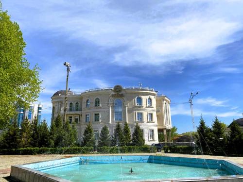 um grande edifício com uma piscina em frente em Royal BV em Ustʼ-Kamenogorsk