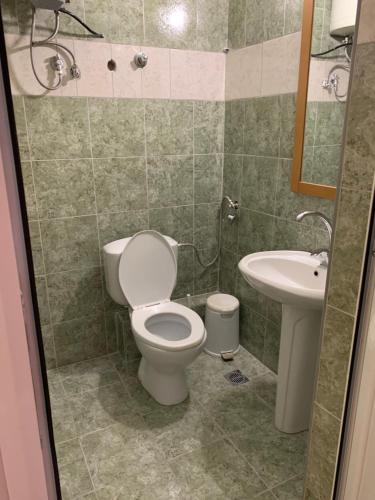 a bathroom with a toilet and a sink at GR Apartments Sea View in Kallithea Halkidikis