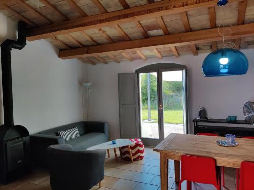 a living room with a table and a couch at Rustico del Bozzo in Castelleone di Suasa